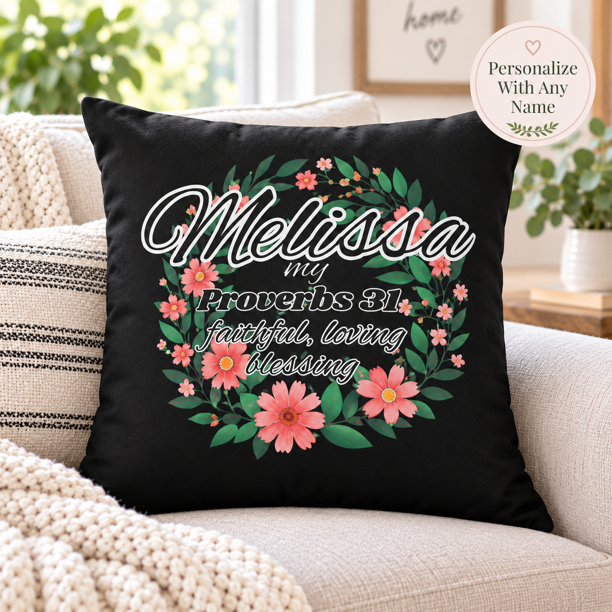 A black throw pillow with a personalized floral wreath design and the text 'Melissa my Proverbs 31 faithful, loving blessing' resting on a beige sofa in a living room setting. A circular badge in the top right corner reads 'Personalize With Any Name'.