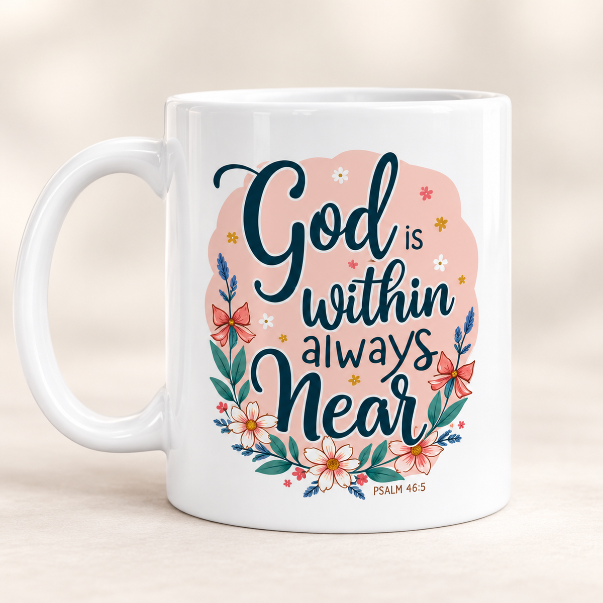 A white ceramic coffee mug with a pink and teal graphic that reads 'God is within always Near' surrounded by floral illustrations, set against a soft beige background.