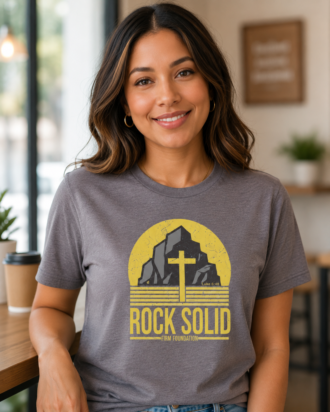 Woman wearing a heather storm Rock Solid Christian T-shirt in a warm everyday lifestyle setting