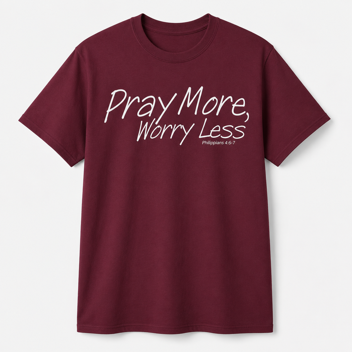 A maroon short-sleeve crewneck t-shirt with the text 'Pray More, Worry Less' and 'Philippians 4:6-7' printed in white on the chest, displayed against a light gray background.
